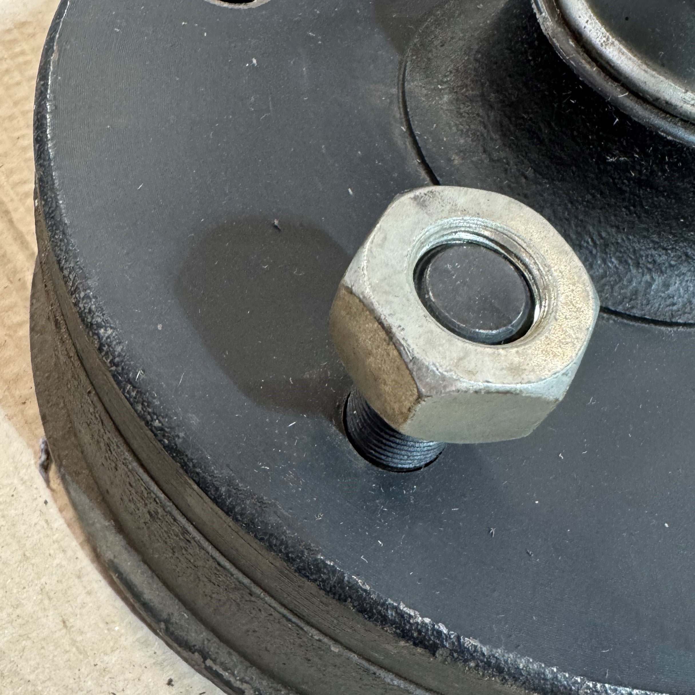 Wheel nut fitted to stud on brake drum