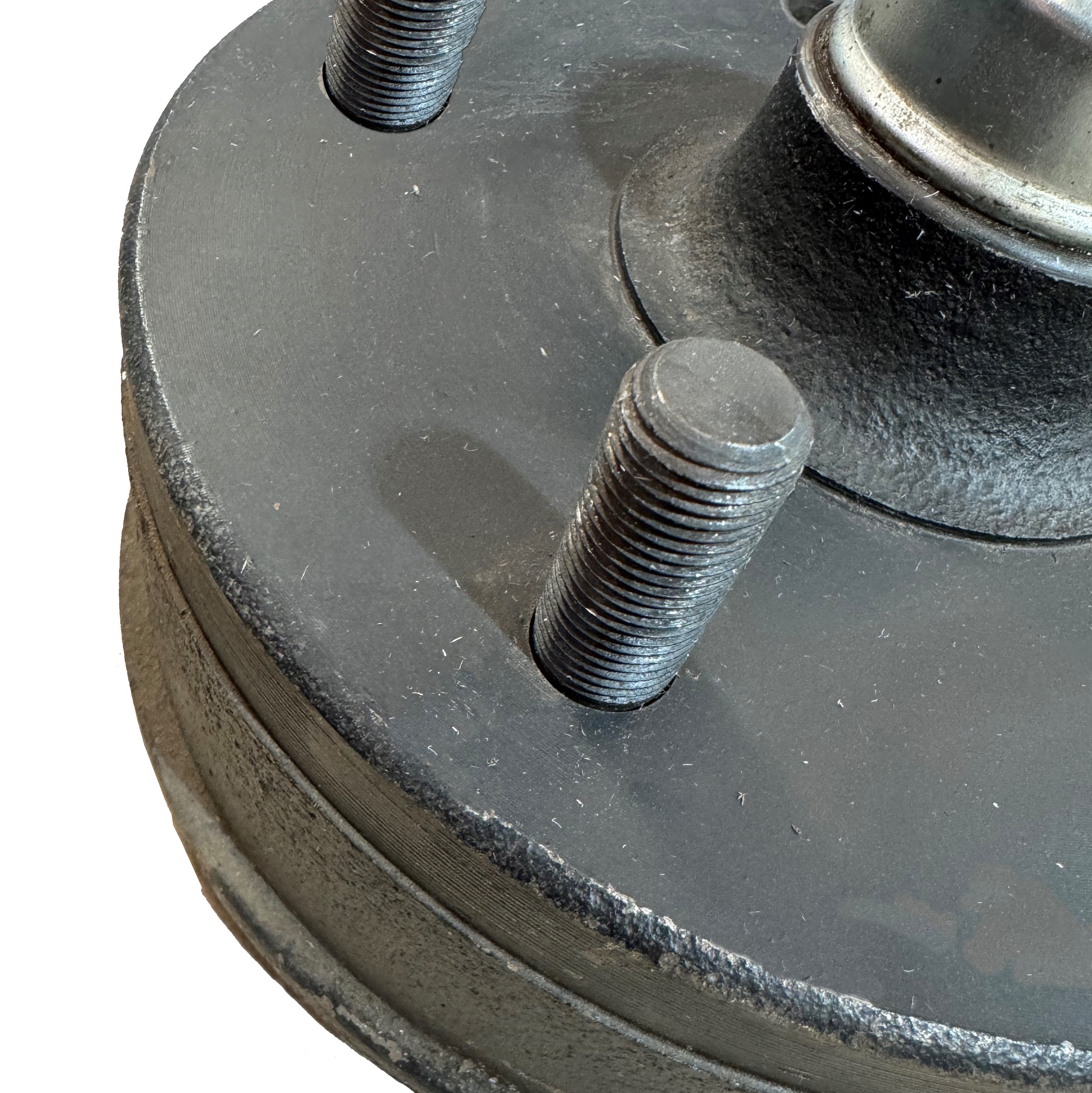 Shows wheel stud in brake drum